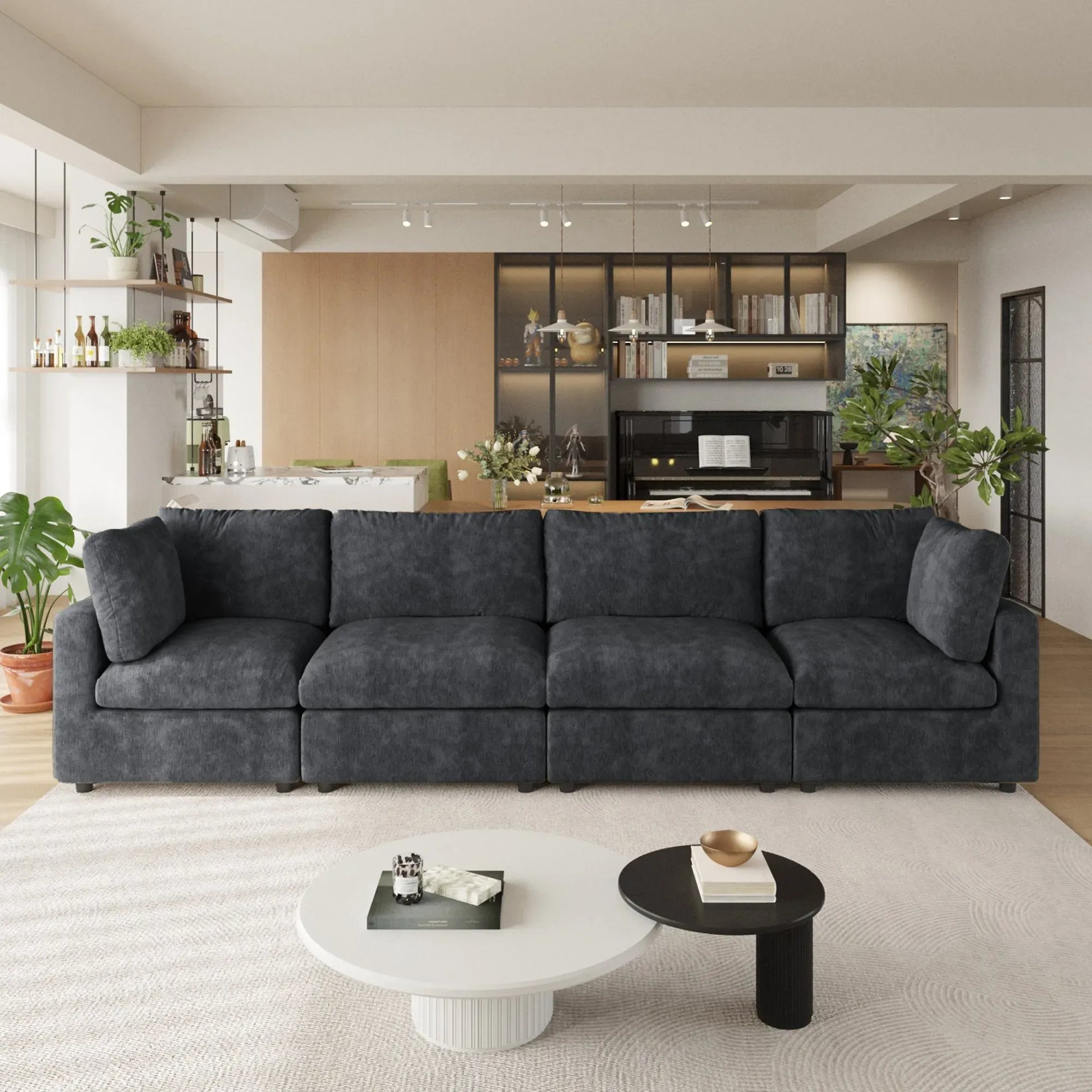 Black 4-seater sectional sofa in a modern living room with coffee tables and decor.