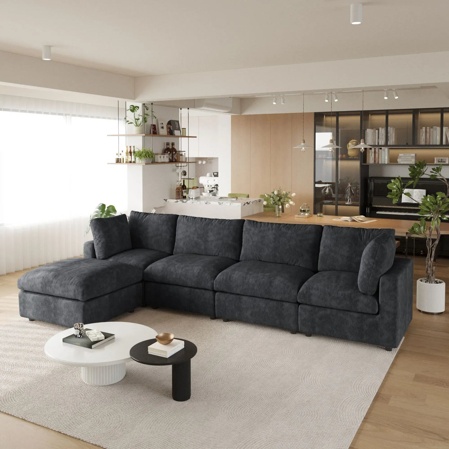 Modern living room with a black L-shaped 5-seater sectional sofa, coffee table, and decorative items.