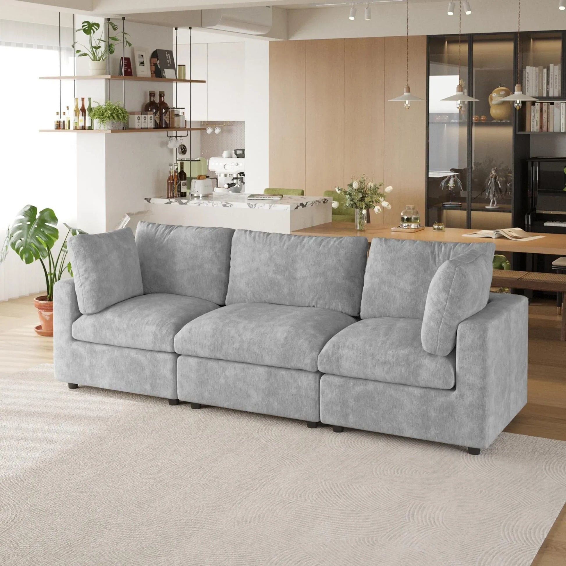 Gray 3-seater sofa in a modern living room with a kitchen in the background