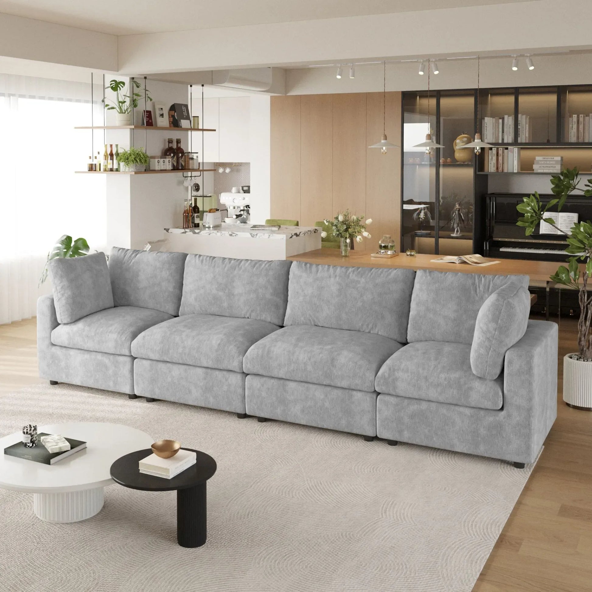Gray 4-seater sectional sofa in a modern living room with kitchen in the background