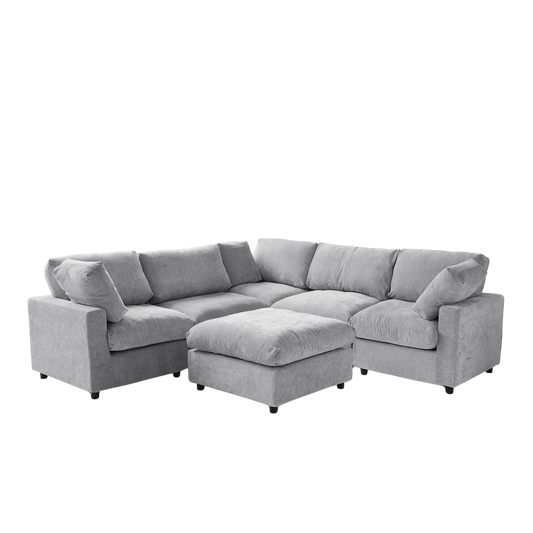 Gray V-shaped corner sectional sofa with ottoman on a white background