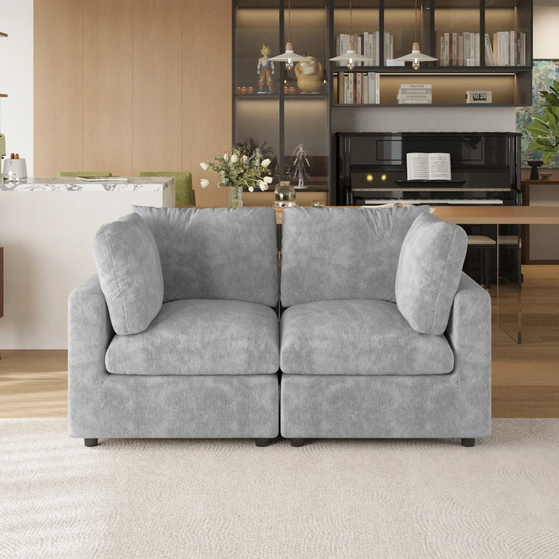 Gray sofa in a living room setting with a bookshelf and table in the background.