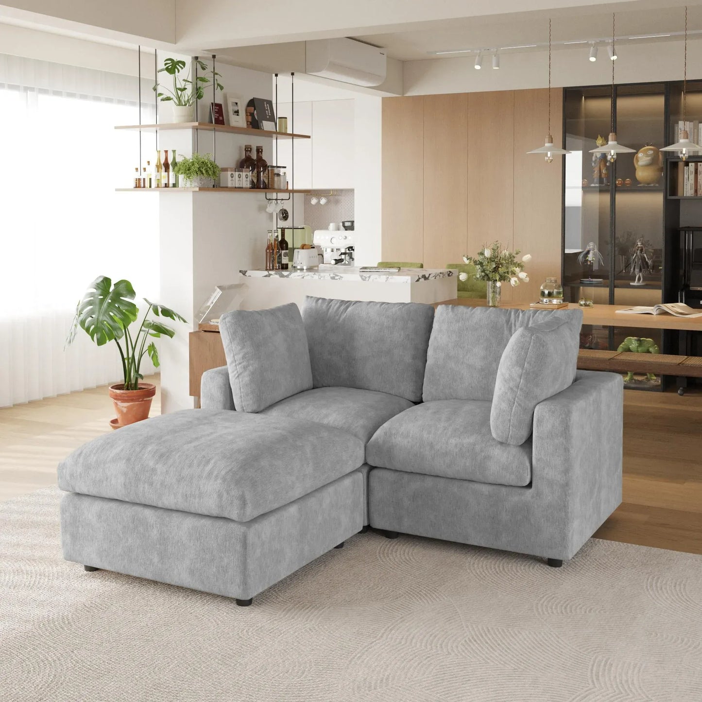 Gray sectional sofa in a modern living room with kitchen in the background