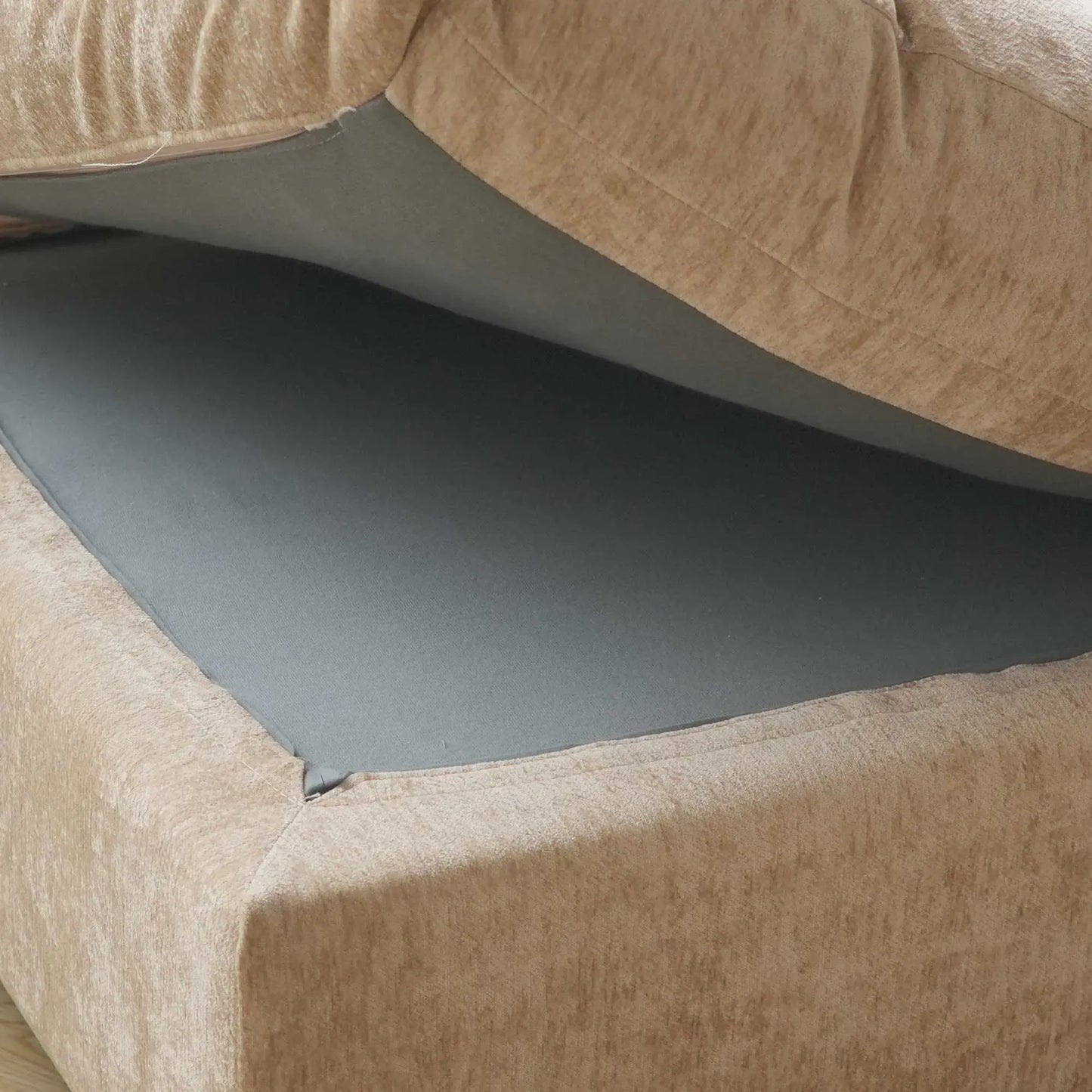 Close-up of a frame under seat cushion of a khaki colored sofa