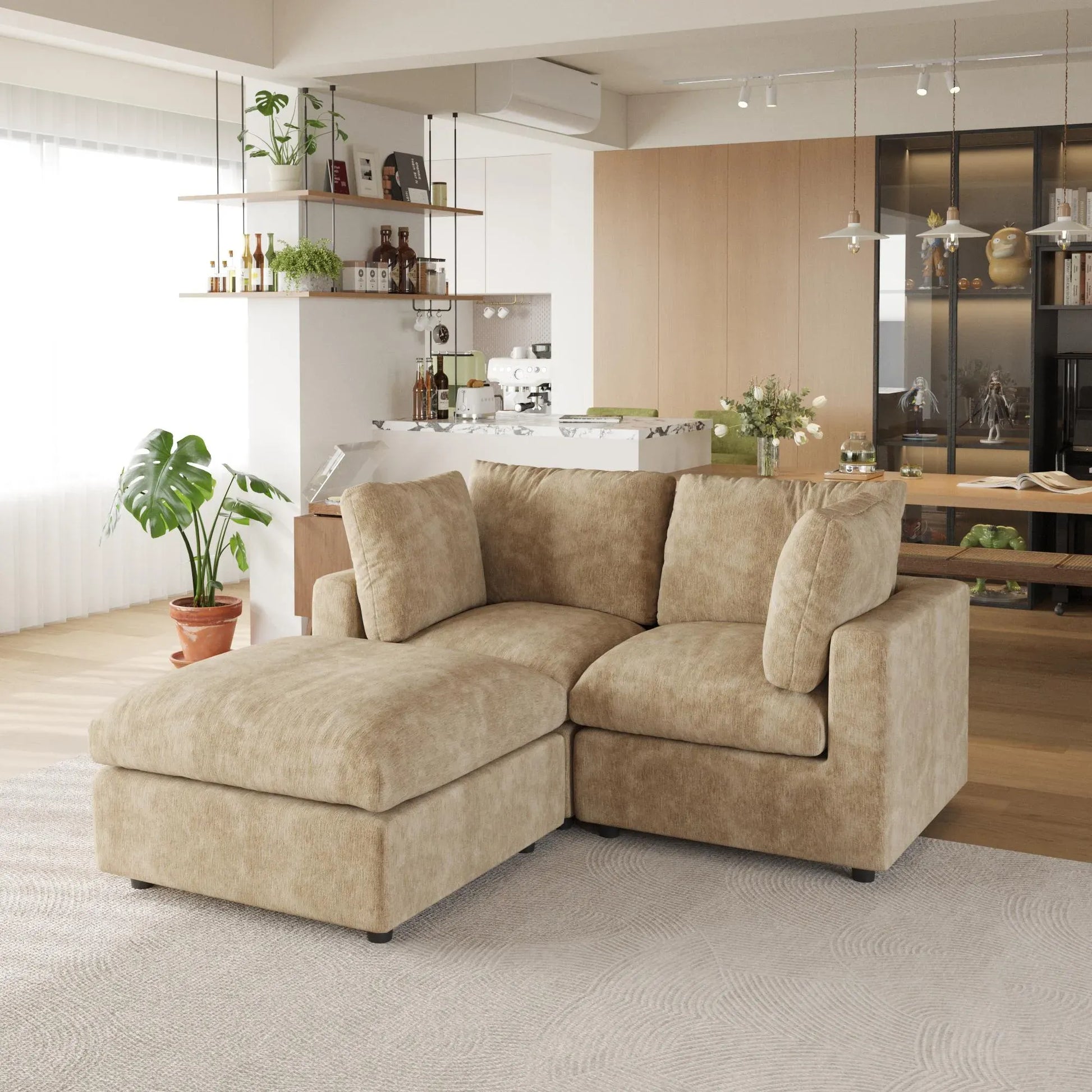Khaki sectional sofa in a modern living room with kitchen in the background