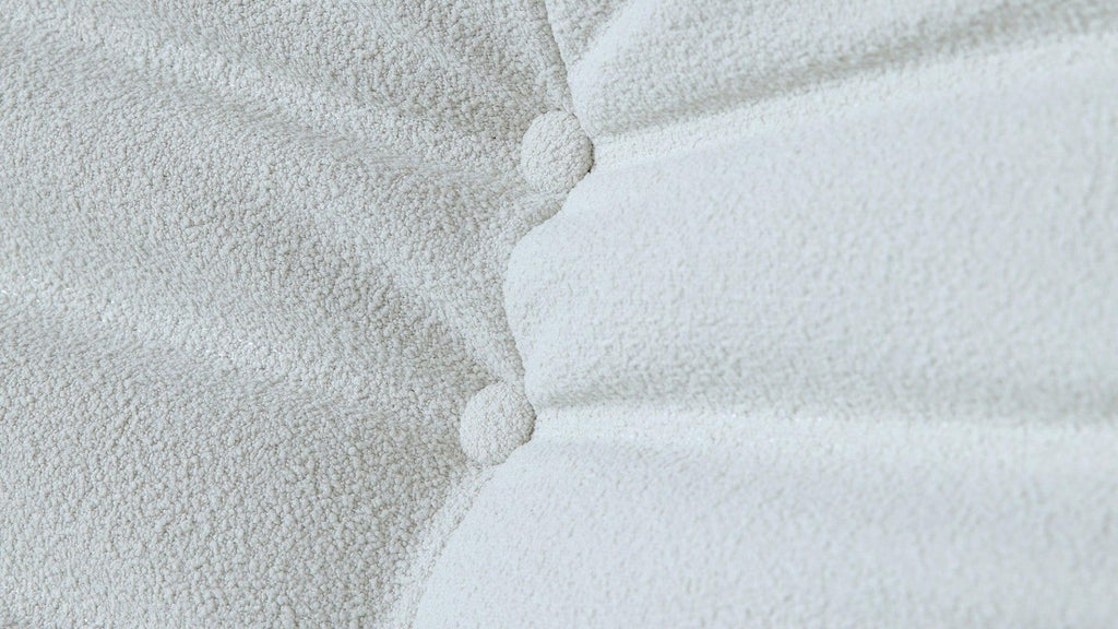 Close-up of buttons of a white togo-style sofa