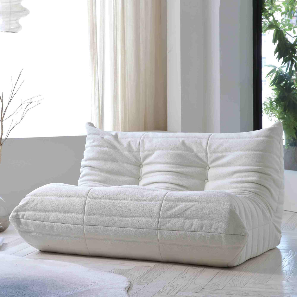 A white, caterpillar-shaped Togo sofa