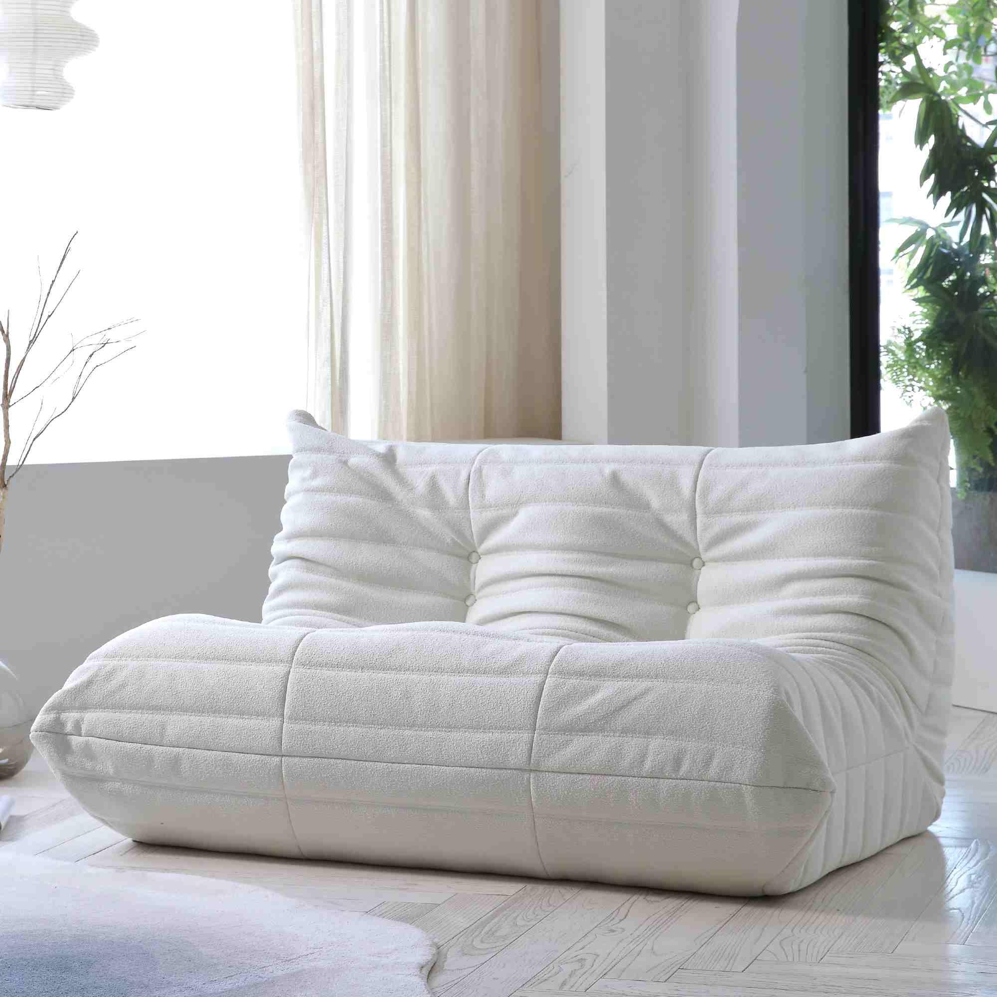 A white, caterpillar-shaped Togo sofa