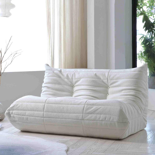 A white, caterpillar-shaped Togo sofa