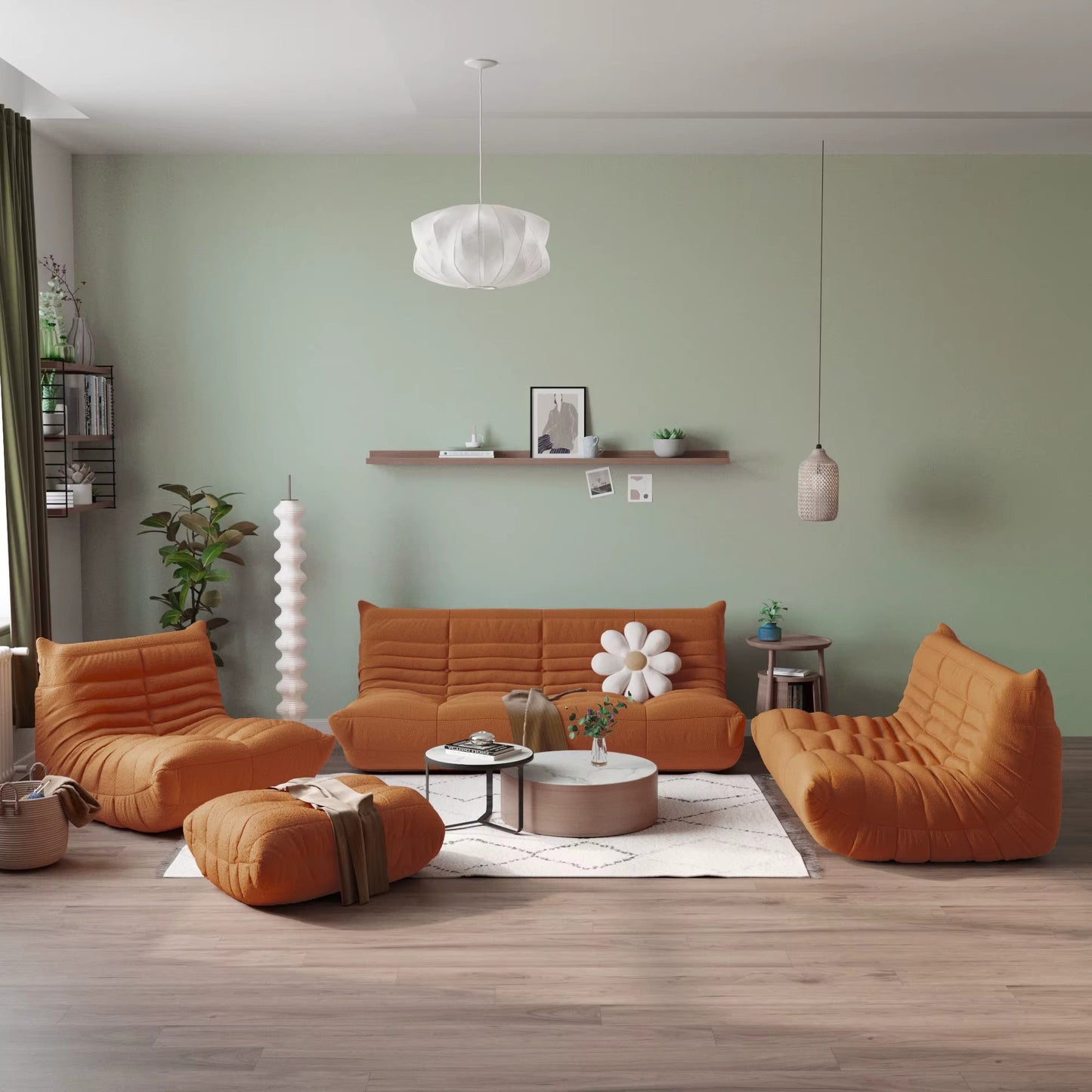 Modern living room with brown togo-style sofa and chairs against a green wall.