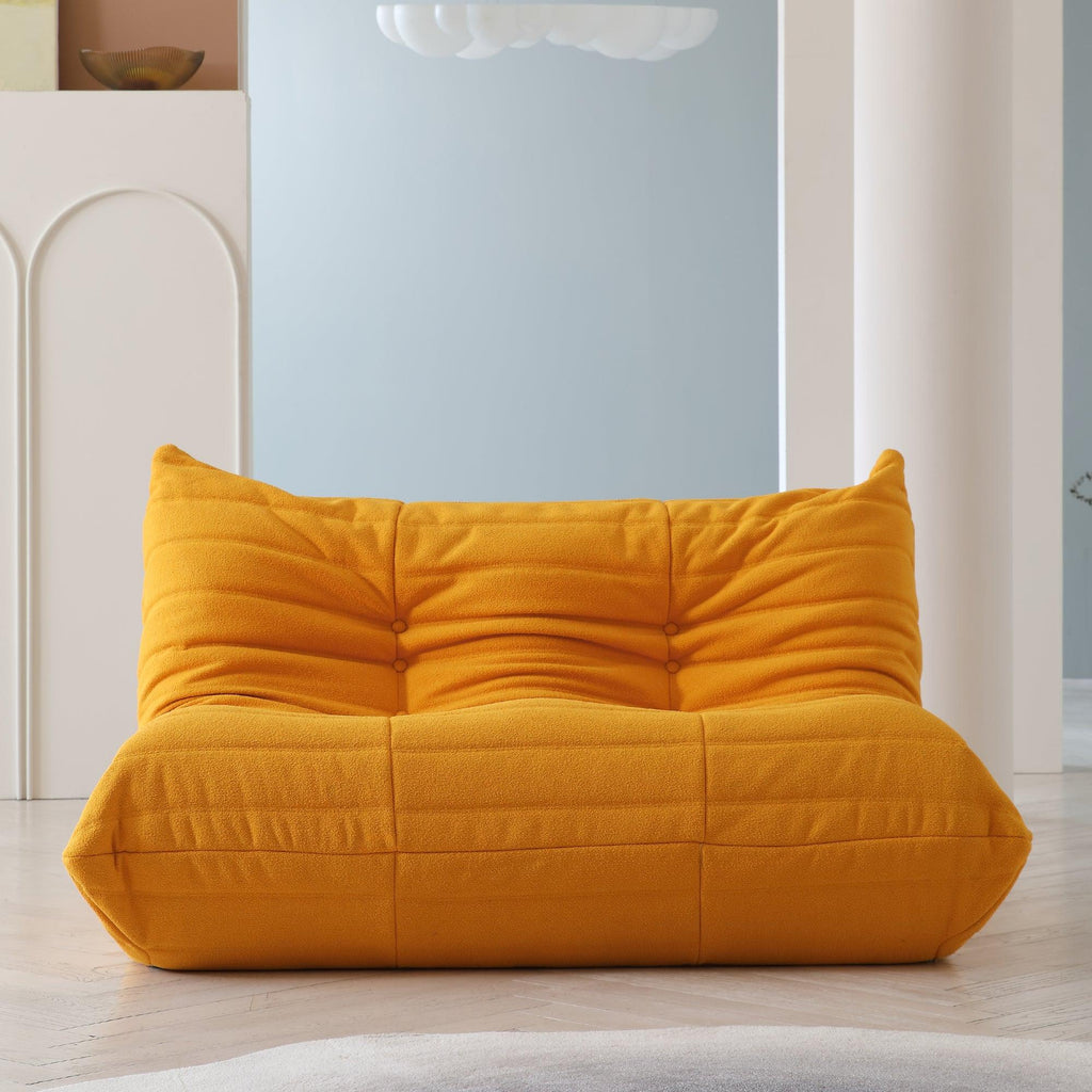 An orange, caterpillar-shaped Togo sofa.