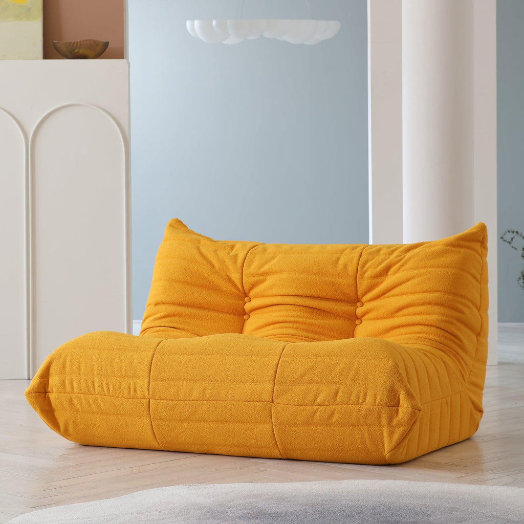An orange, caterpillar-shaped Togo sofa.