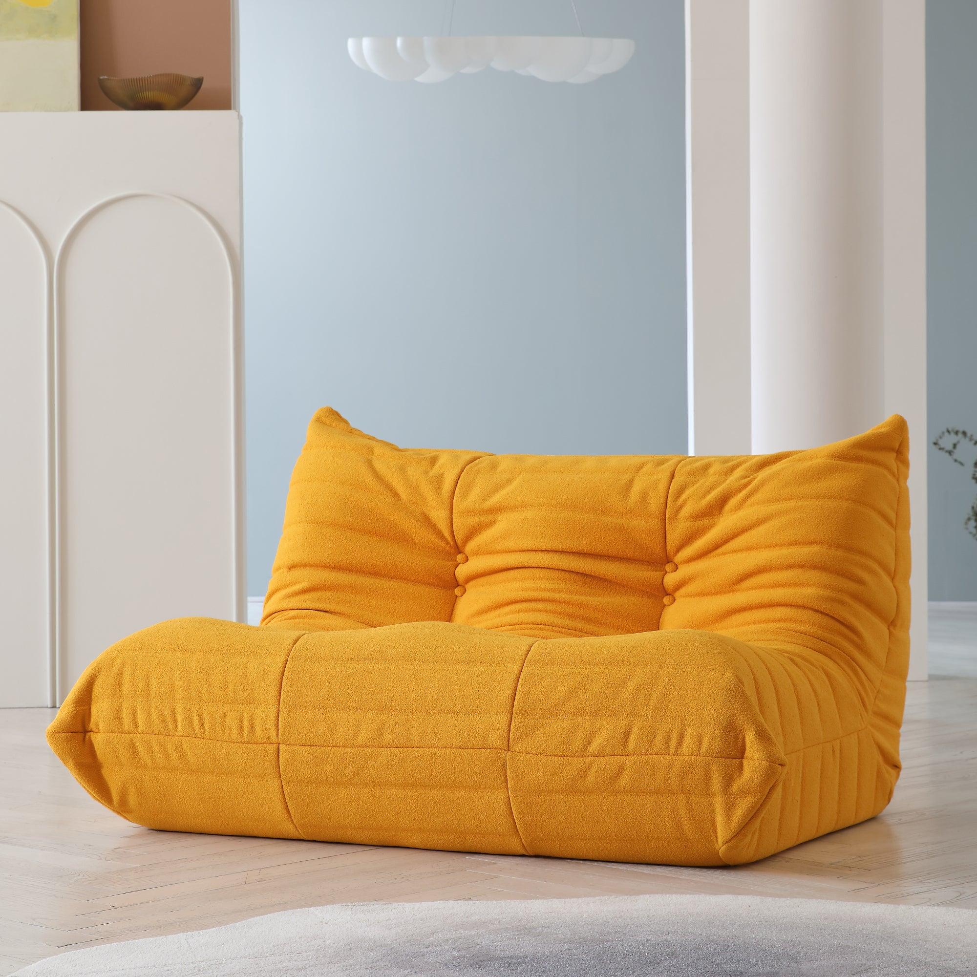 An orange, caterpillar-shaped Togo sofa.
