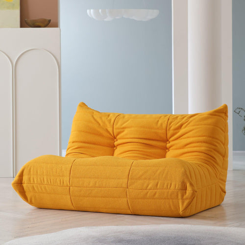 An orange, caterpillar-shaped Togo sofa.