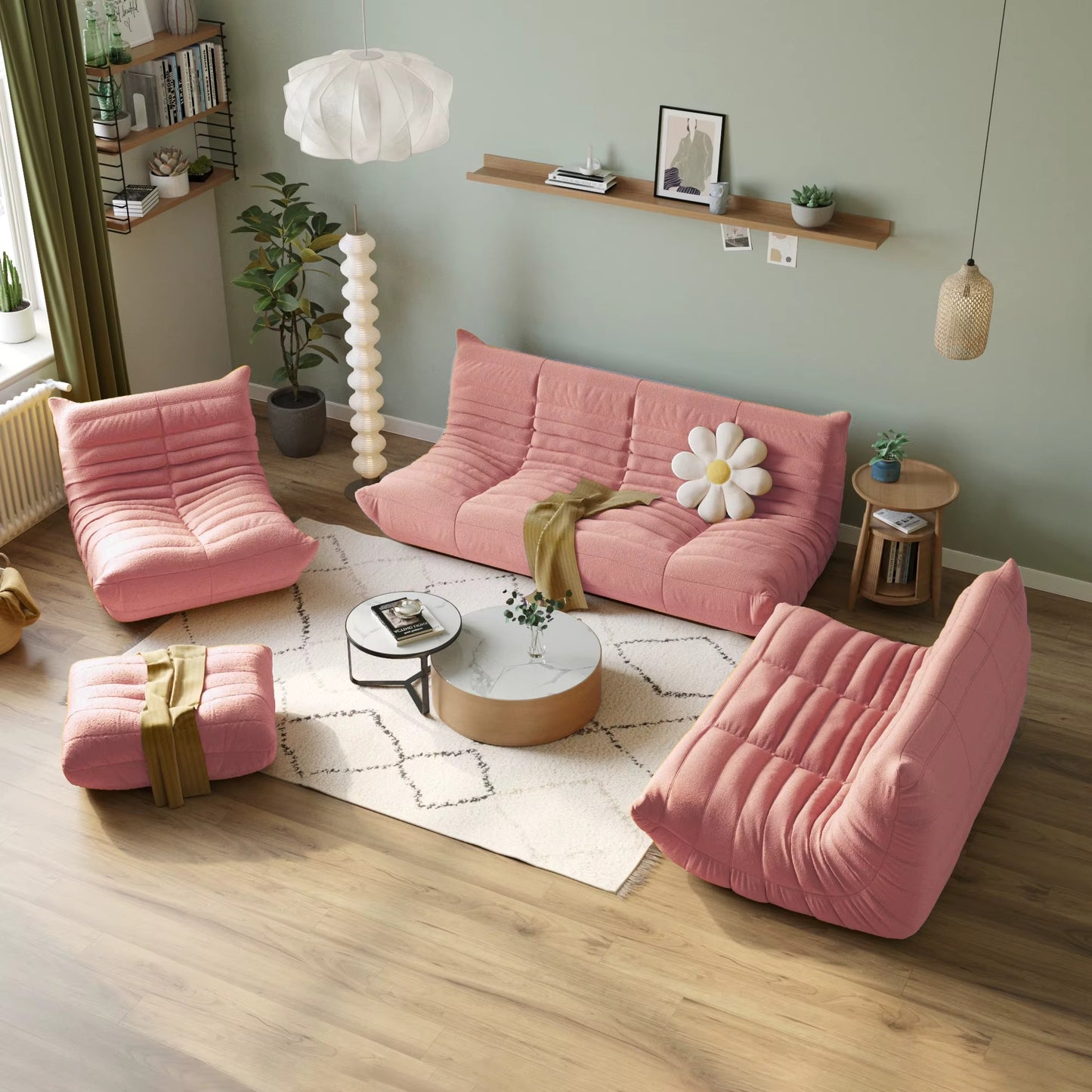 Pink sofa and armchairs in a living room with decor elements.