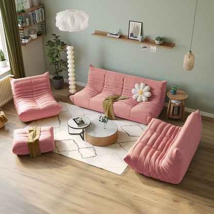 Pink sofa and armchairs in a living room with decor elements.