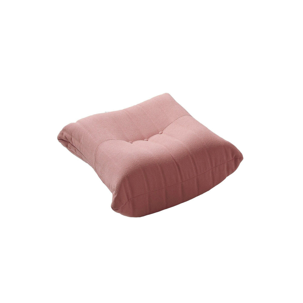A distinctive caterpillar-shaped pink upholstered ottoman with a soft, plush appearance.
