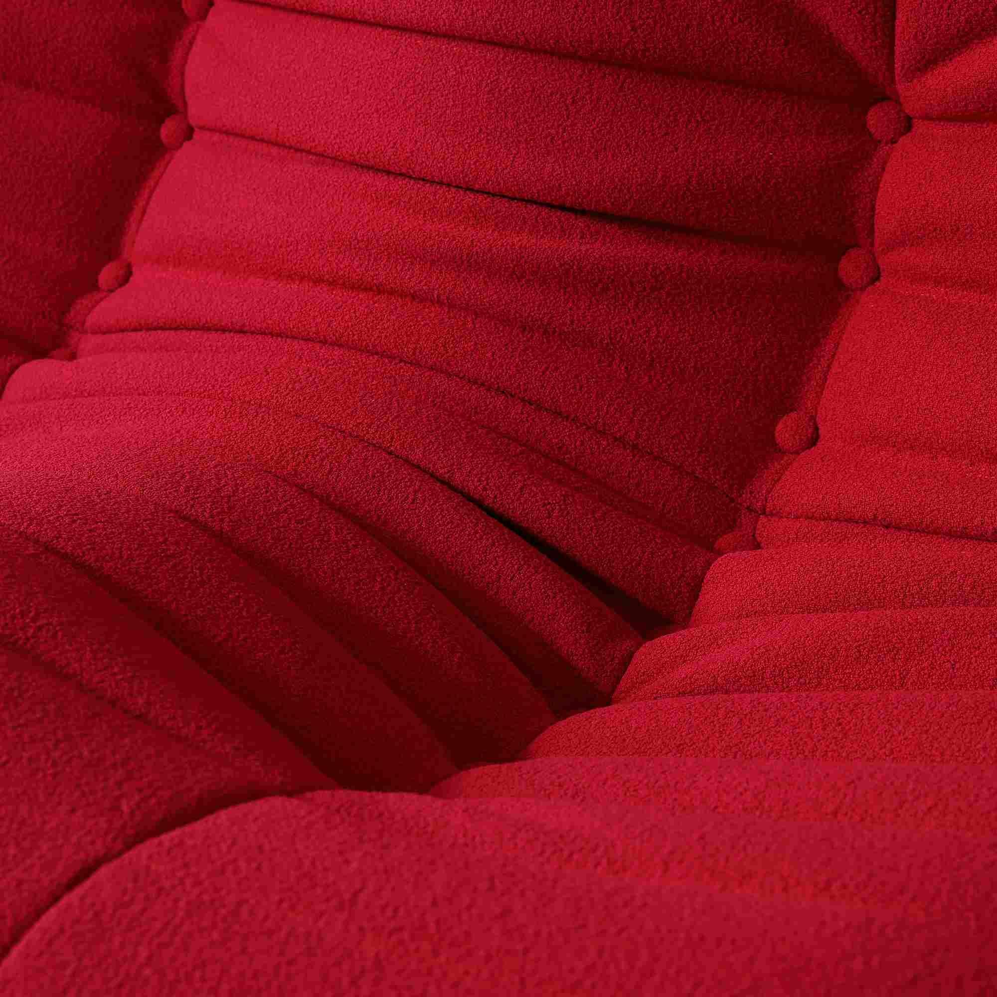 Close-up of a fabric of a caterpillar design of a red togo style sofa