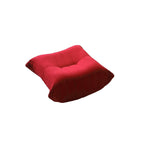 A distinctive caterpillar-shaped red upholstered ottoman with a soft, plush appearance.