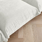 Beige chenille overstuffed sofa seat detail.