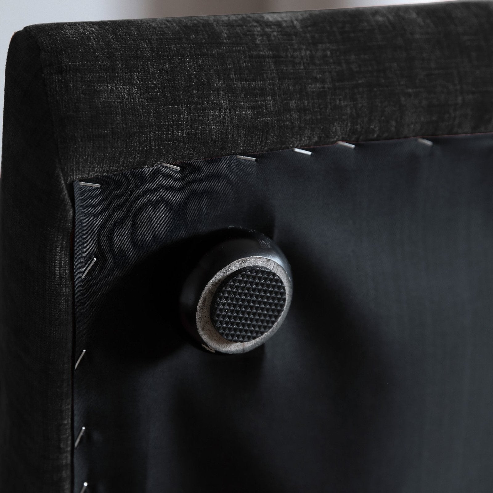 Black overstuffed chenille armchair leg detail
