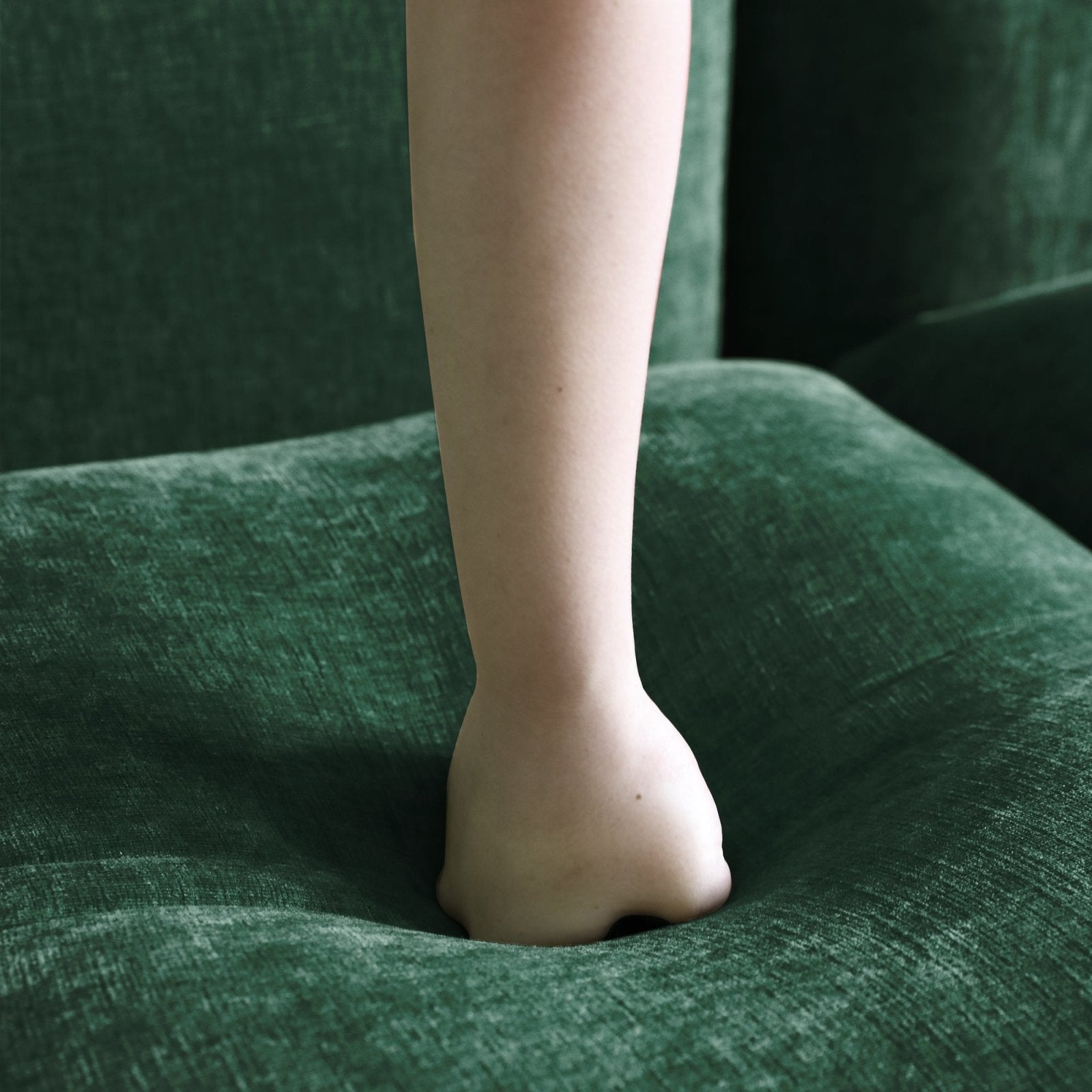 Emerald green chenille overstuffed sofa foam density detail.