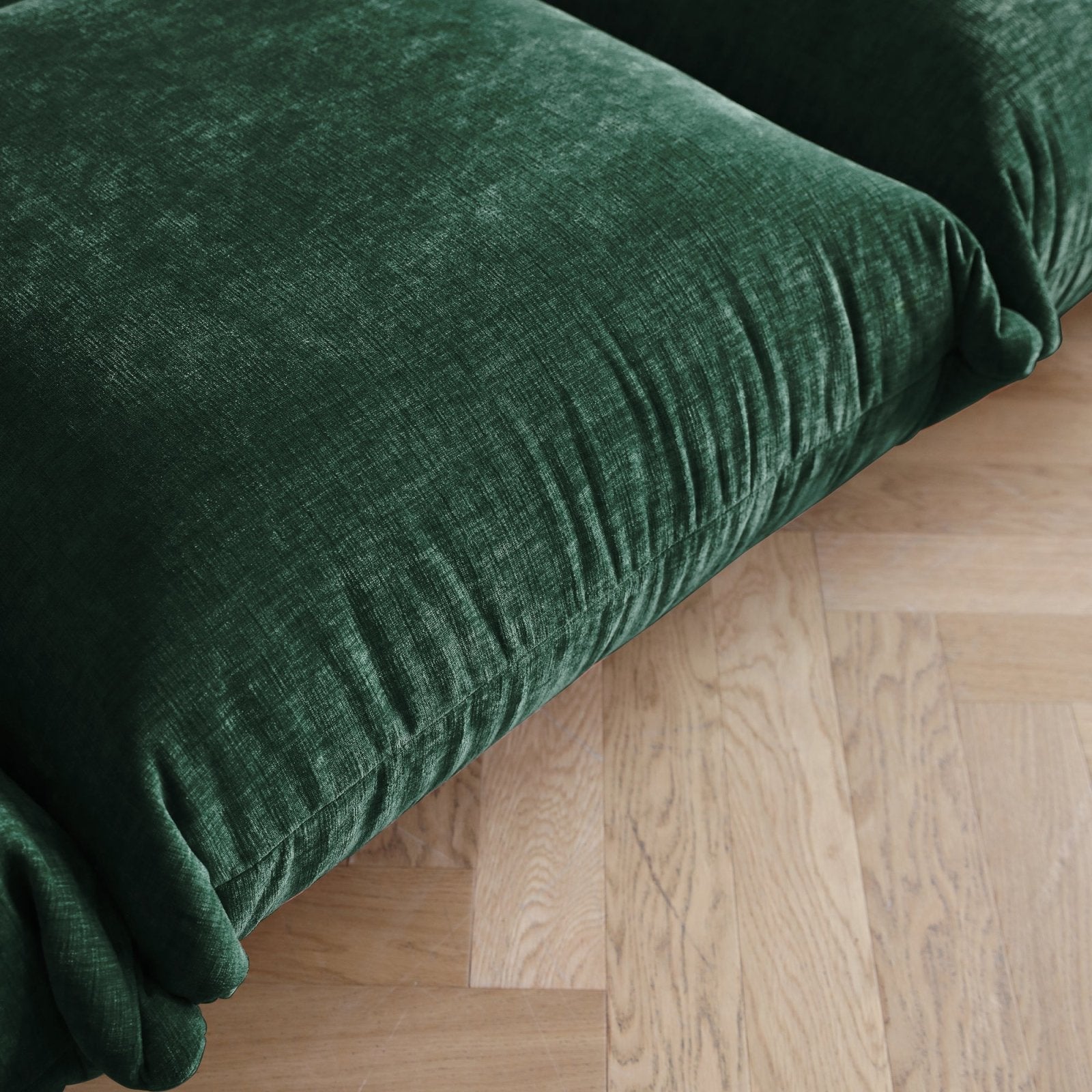 Emerald green chenille overstuffed sofa seat detail.