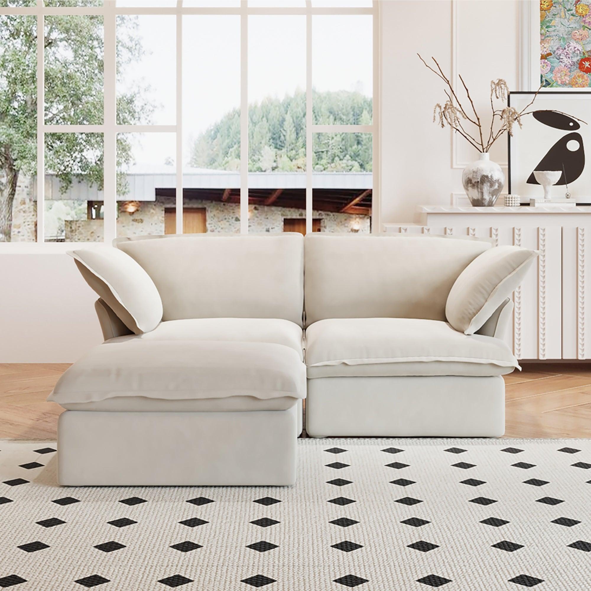 A beige chaise lounge loveseat linen sectional sofa with a modular design and a storage ottoman, placed on a patterned rug in a bright living space.
