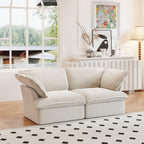 A beige loveseat linen sectional sofa with modular design placed on a patterned rug in a bright living room setting.