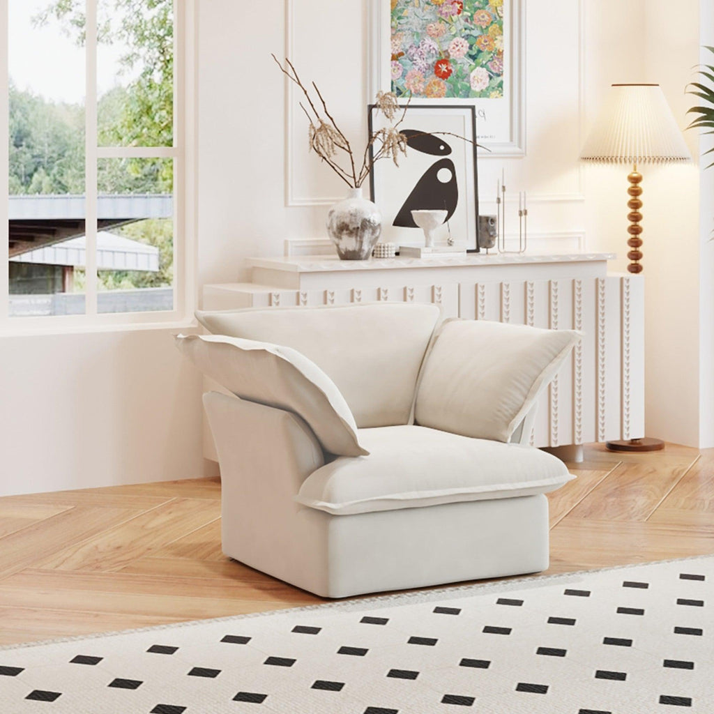 A beige linen armchair with a solid frame and washable covers, placed on a patterned rug in a bright room.