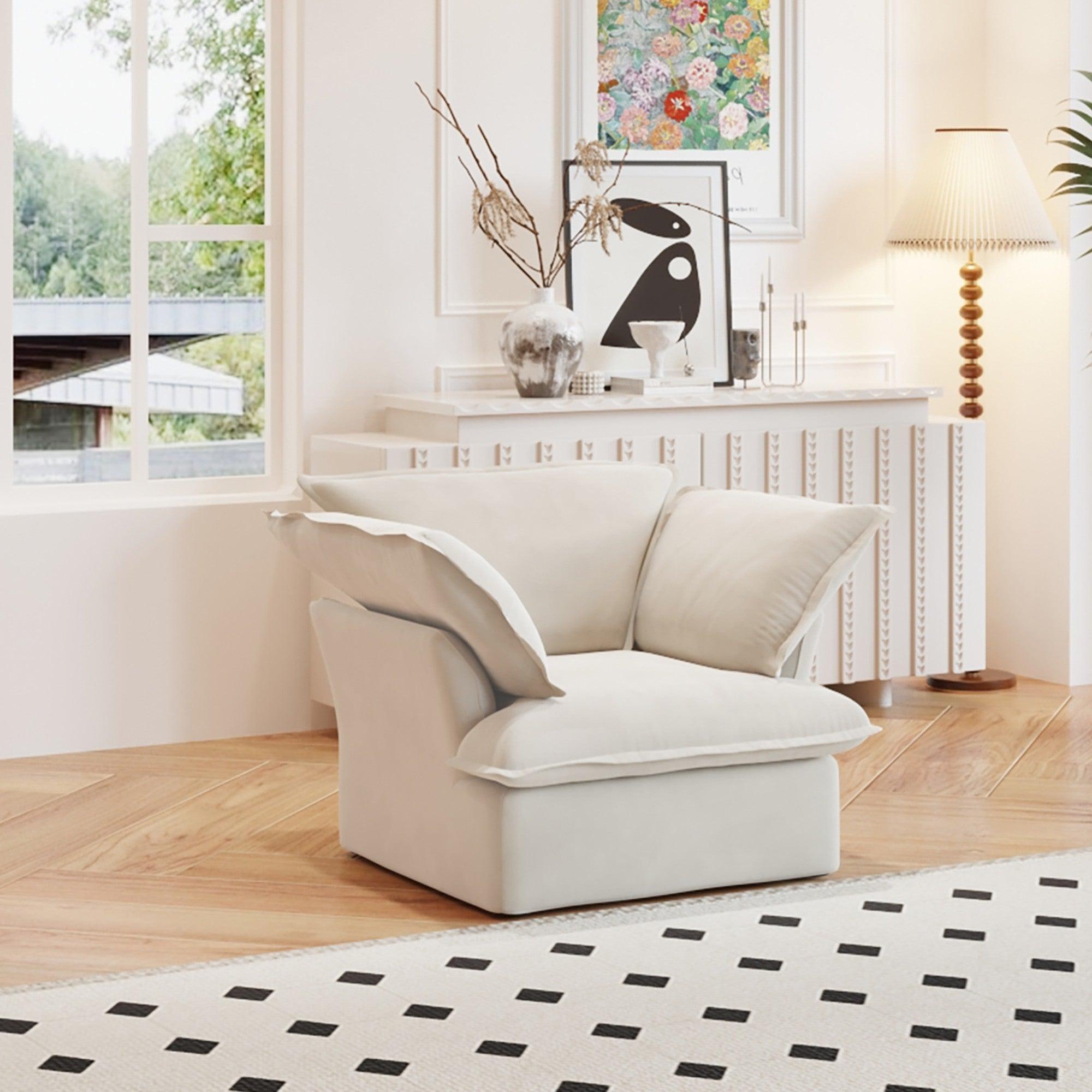 A beige linen armchair with a solid frame and washable covers, placed on a patterned rug in a bright room.