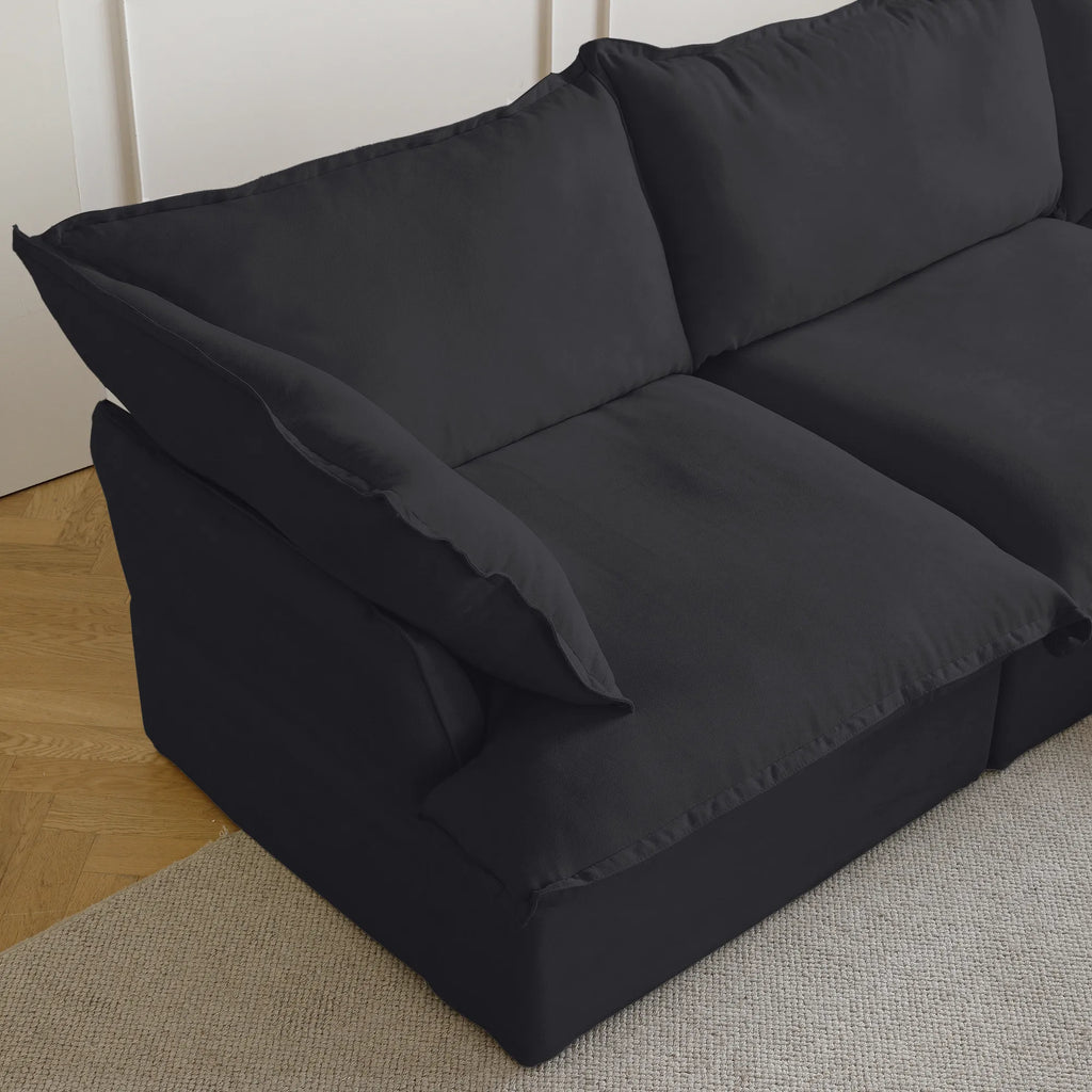 Close-up of a armrest seat of a black sectional sofa
