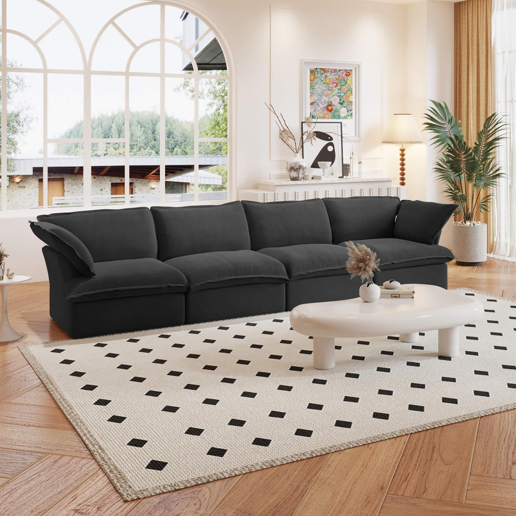 A black linen sectional modular 4-seat sofa arranged in a living room setting with deep seating.