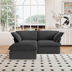 A black chaise lounge loveseat linen sectional sofa with a modular design and a storage ottoman, placed on a patterned rug in a bright living space.
