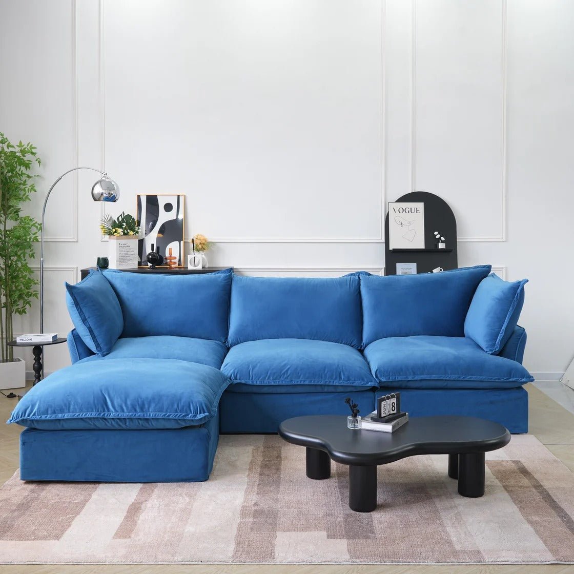 Blue velvet 3-seater L-shaped sectional with washable covers and storage ottoman.