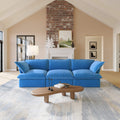 Blue 3-seat sofa in a living room with a wooden coffee table and decorative items.