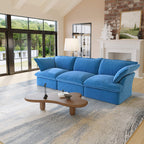Blue 3-seat sofa in a living room with a coffee table and large windows.