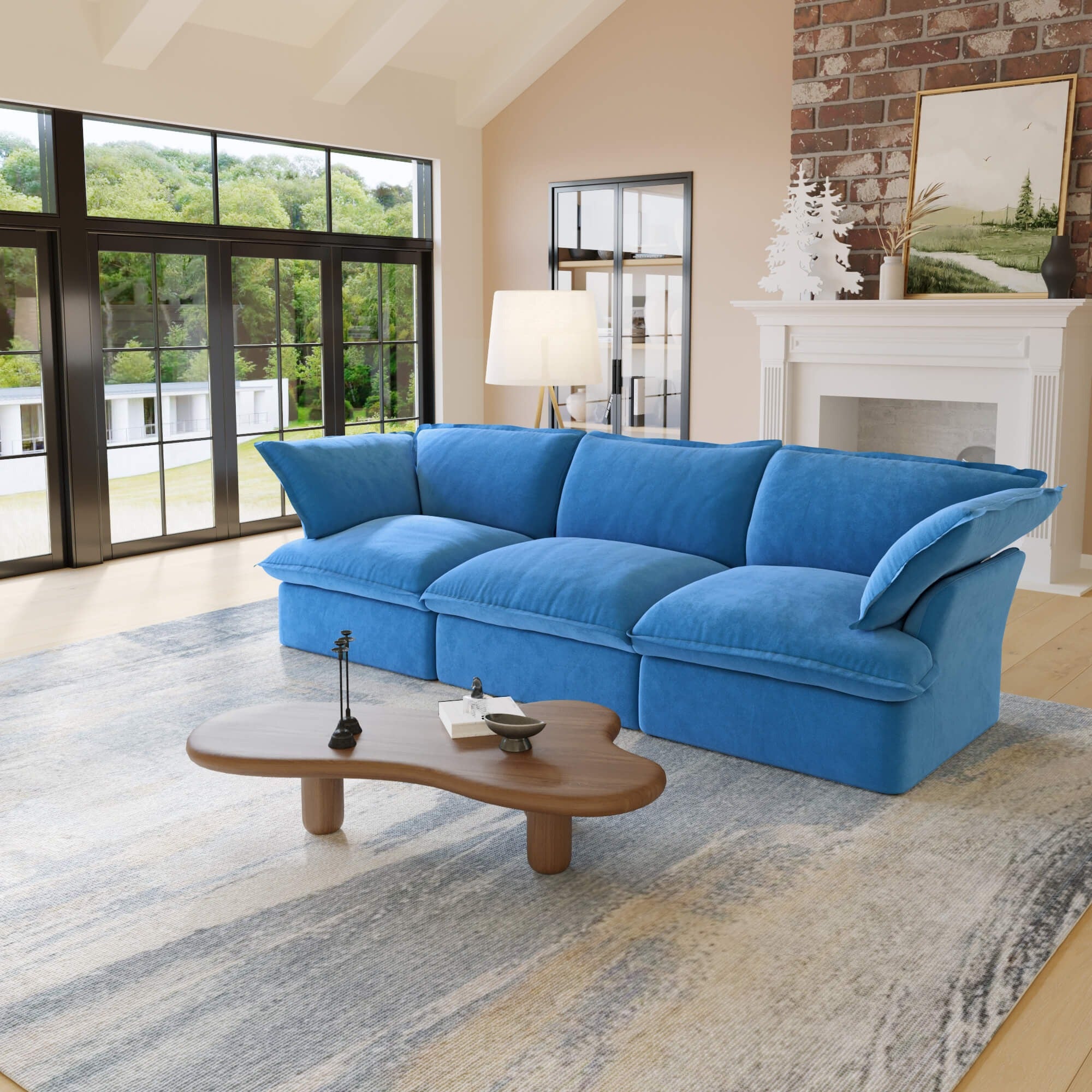 Blue 3-seat sofa in a living room with a coffee table and large windows.