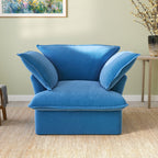 A plush blue velvet modular sectional sofa in a cozy living room setting, with a cushioned backrest and seat.