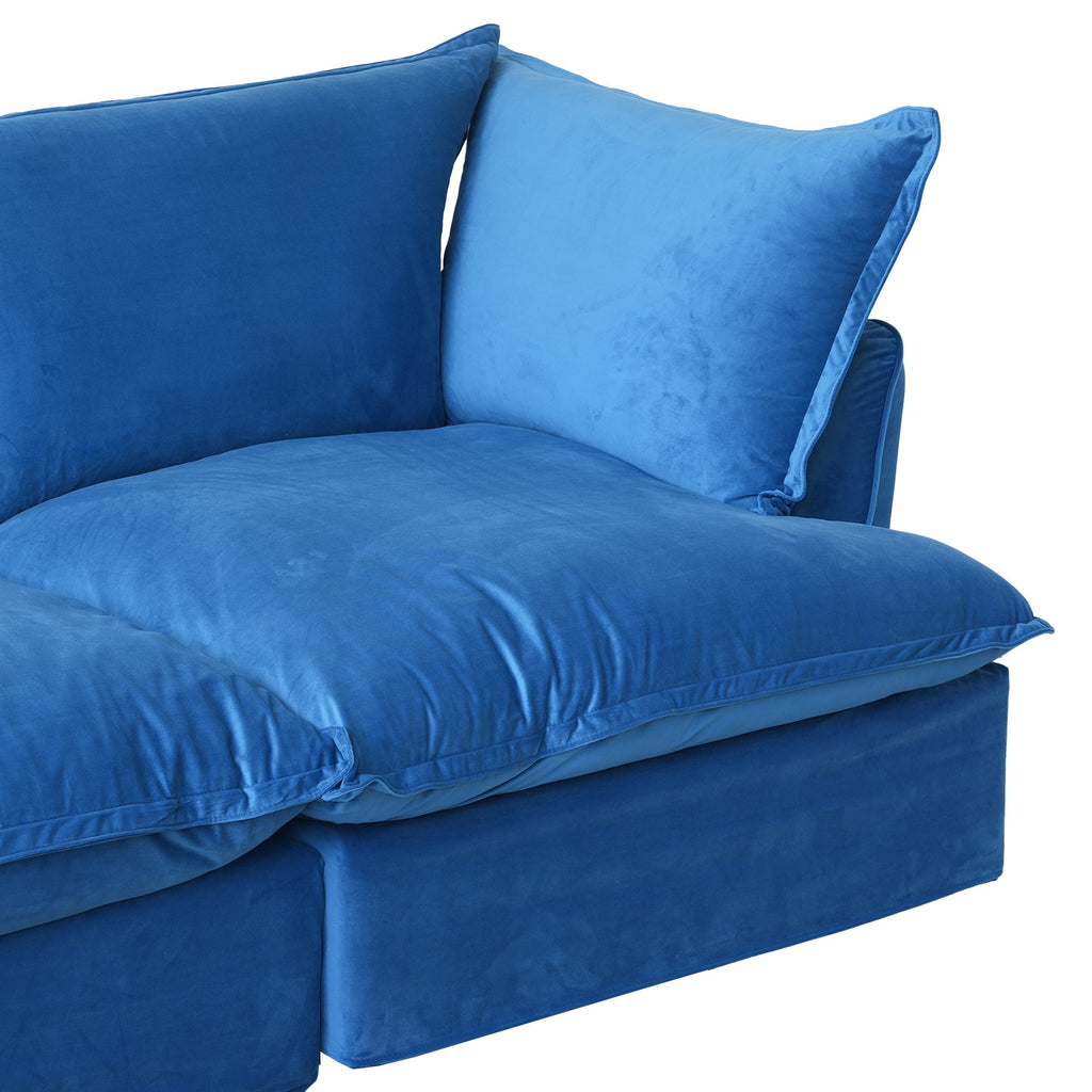 Close-up of the right seat of a blue velvet sofa
