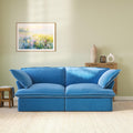 Modular blue velvet loveseat sofa with curved armrests, front