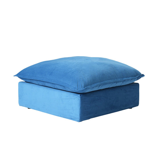 A blue velvet ottoman with a cushioned top, designed as a modular sectional sofa piece.