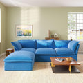 An L-shaped velvet sectional sofa in blue color, with a replaceable cover, arranged in a living room setting.