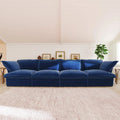 Dark blue 4-seat sofa in a living room setting with a neutral color palette