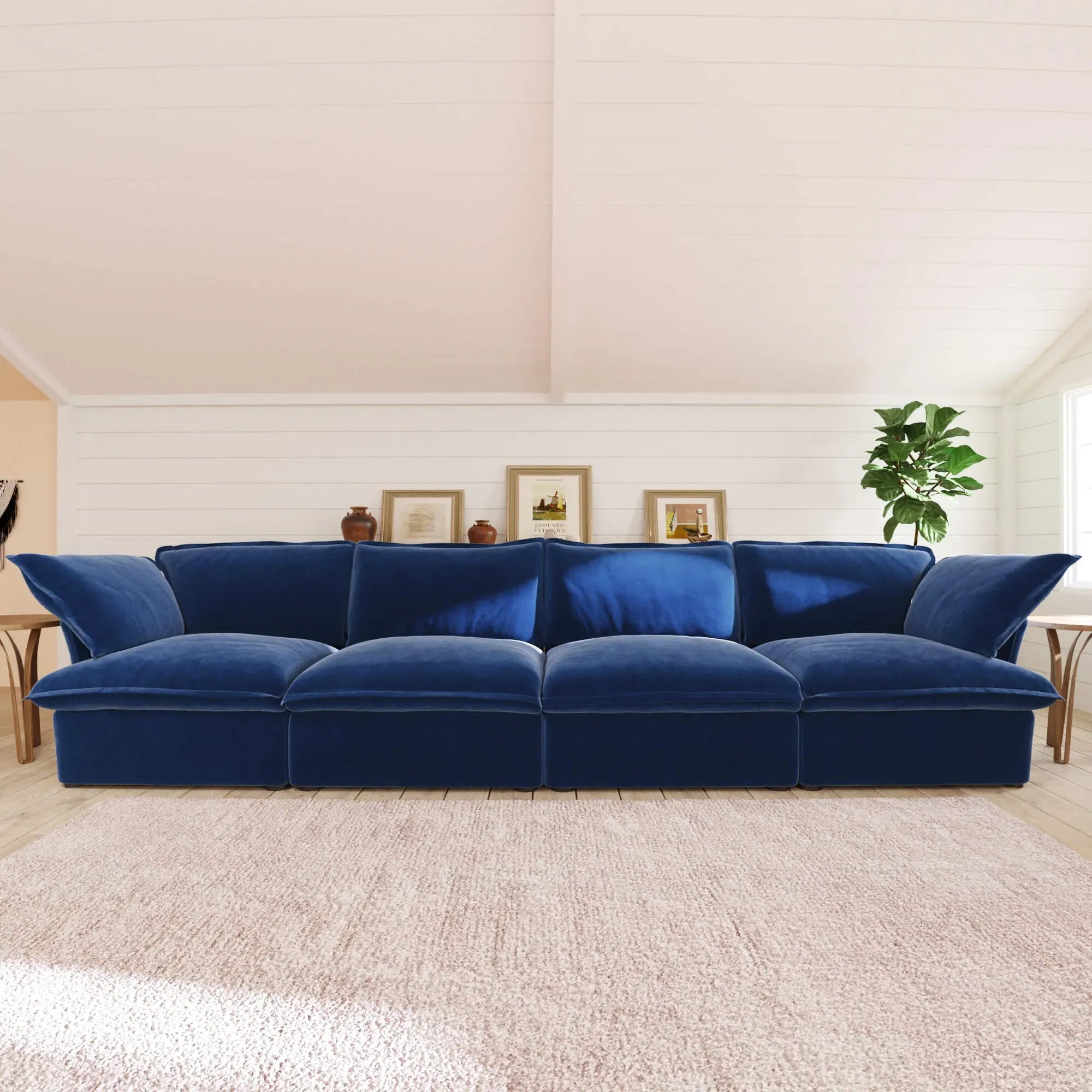 Dark blue 4-seat sofa in a living room setting with a neutral color palette