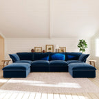 Dark blue U-shaped sectional sofa in a living room with wooden floor and white walls