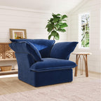 Dark blue armchair in a room with a plant and window