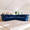 Dark blue corner sectional sofa in a room with white walls and wooden floor.