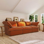 Dark orange sectional sofa in a room with wooden floors and white walls.