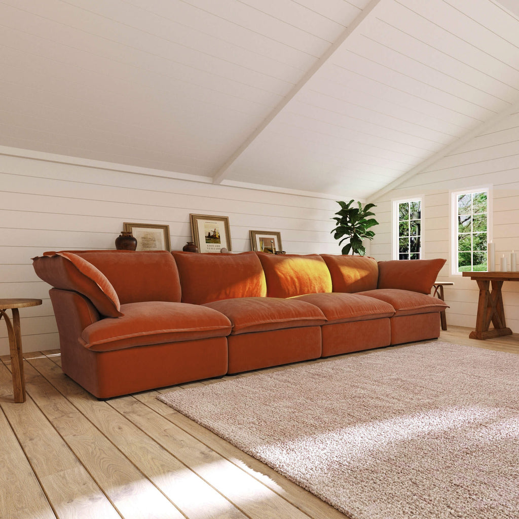 Dark orange 4-seat sectional sofa in a room with wooden floor and white walls
